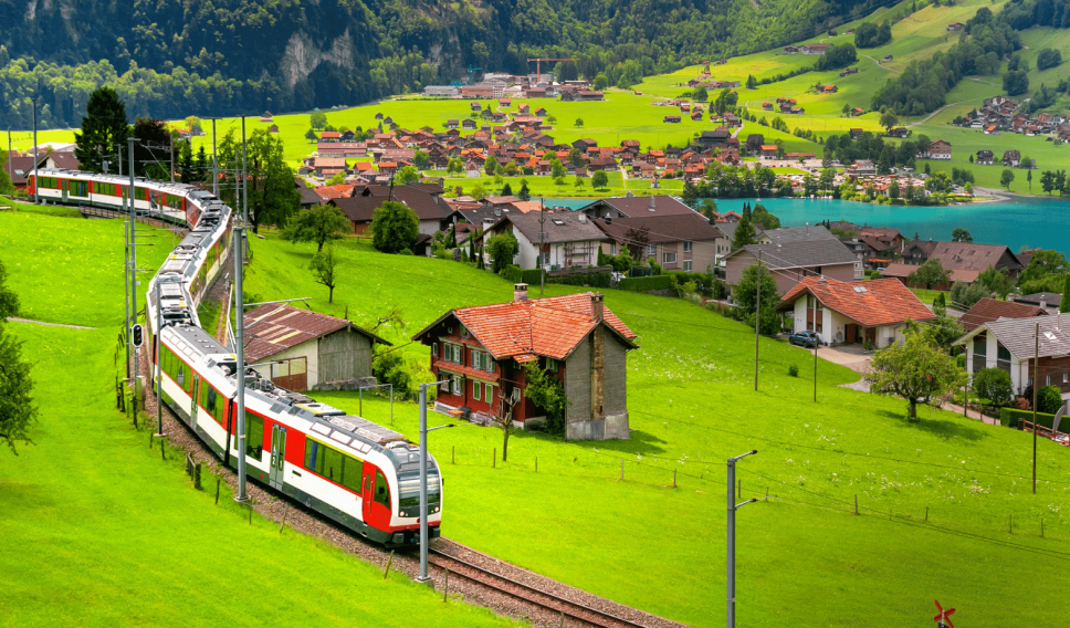 Tourist train passing through a Swiss village