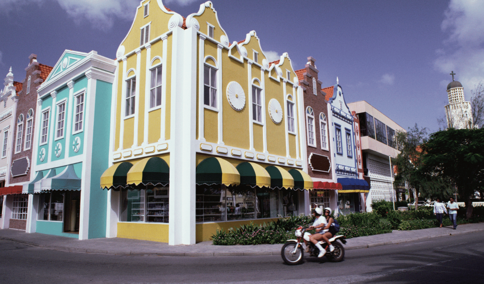 Colorful buildings and motorcycle, Oranjestad, Aruba