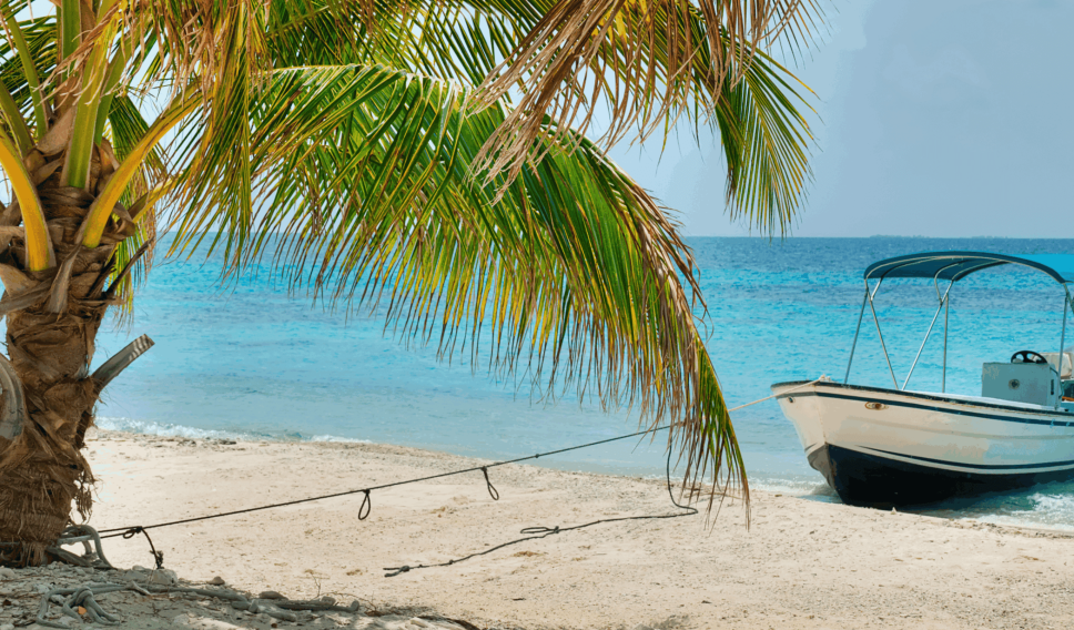 Boat floating off an island in Belize getty images
